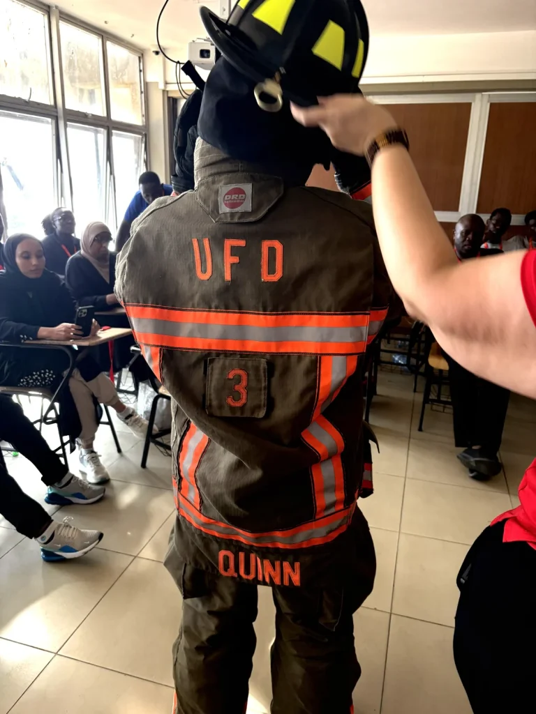 Former Union Fire District Deputy Chief Kevin Quinn showed his turnout gear and personal protection equipment to a group of students in a Kenyan classroom.
